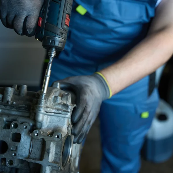 car-mechanic-repairing-automobile-engine-in-garage-2025-03-05-14-48-53-utc